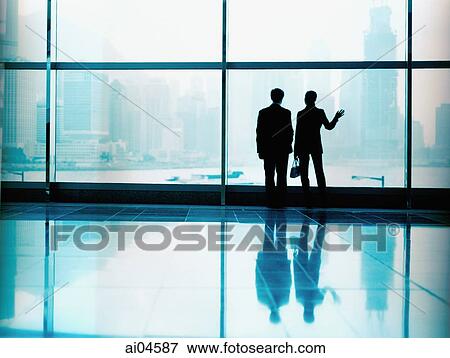 Executive pair in front of large window, silhouette. View Large Photo Image Stock Photo - Executive pair in front of large window, silhouette.. Fotosearch