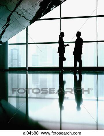 Executive pair in front of large window, silhouette. View Large Photo Image Stock Photo - Executive pair in front of large window, silhouette.. Fotosearch