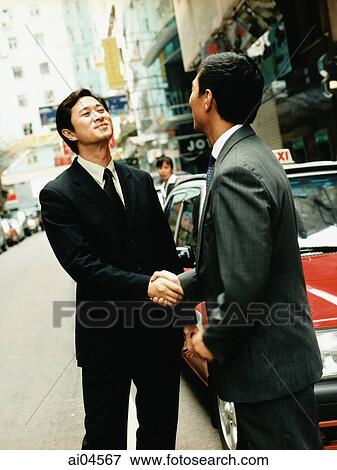 Executive pair shaking hands on street. View Large Photo Image Stock Photo - Executive pair shaking hands on street.. Fotosearch