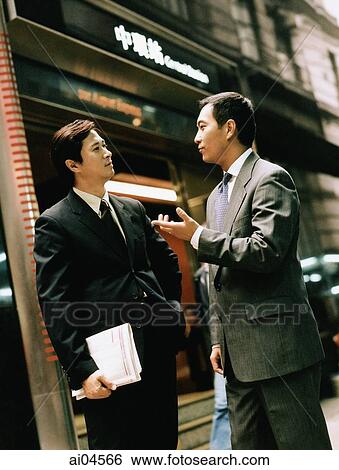 Executive pair talking on street. View Large Photo Image Stock Photograph - Executive pair talking on street.. Fotosearch
