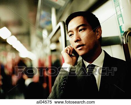 Executive using cellular phone in train. View Large Photo Image Stock Photography - Executive using cellular phone in train.. Fotosearch