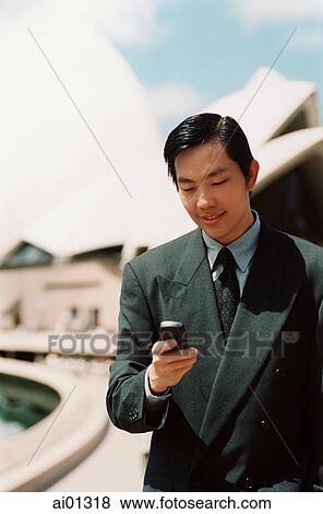 Executive using cellular phone, Sydney Opera House in background View Large Photo Image Stock Photo - Executive using cellular phone, Sydney Opera House in background. Fotosearch