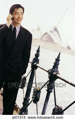 Executive using cellular phone, Sydney Opera House in background ( high grain) View Large Photo Image Stock Photography - Executive using cellular phone, Sydney Opera House in background ( high grain). Fotosearch