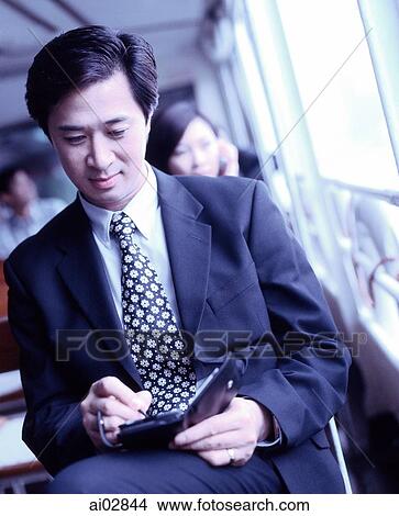 Executive using PDA on ferry. View Large Photo Image Picture - Executive using PDA on ferry.. Fotosearch
