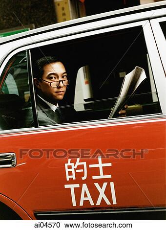 Executive wearing glasses holding newspaper in taxi. View Large Photo Image Stock Image - Executive wearing glasses holding newspaper in taxi.. Fotosearch