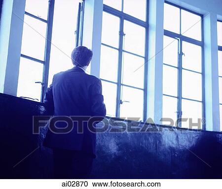 Executive with back to camera looking out window. View Large Photo Image Stock Image - Executive with back to camera looking out window.. Fotosearch