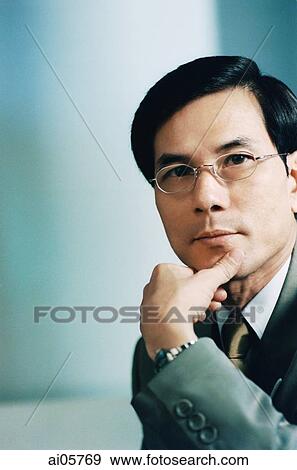 Executive with chin on hand, portrait View Large Photo Image Stock Photo - Executive with chin on hand, portrait. Fotosearch
