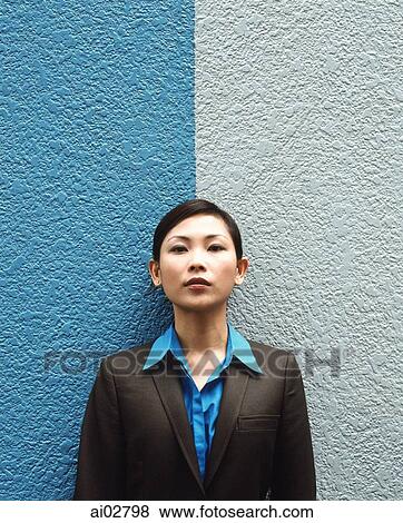 Executive woman standing against split colored background, portrait. View Large Photo Image Stock Photo - Executive woman standing against split colored background, portrait.. Fotosearch