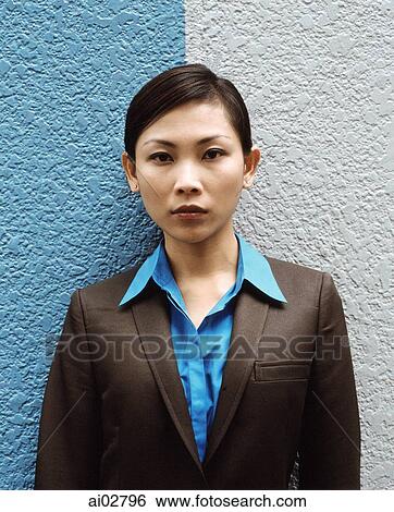 Executive woman standing against split colored background, portrait. View Large Photo Image Stock Photograph - Executive woman standing against split colored background, portrait.. Fotosearch