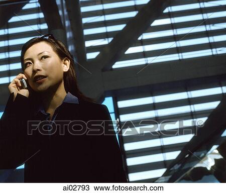 Executive woman using cellular phone indoors. View Large Photo Image Stock Image - Executive woman using cellular phone indoors.. Fotosearch