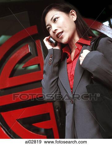 Executive woman using cellular phone, chinese pattern in background. View Large Photo Image Stock Photo - Executive woman using cellular phone, chinese pattern in background.. Fotosearch