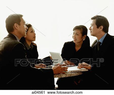 Executives meeting around table with laptop, white background. View Large Photo Image Stock Image - Executives meeting around table with laptop, white background.. Fotosearch