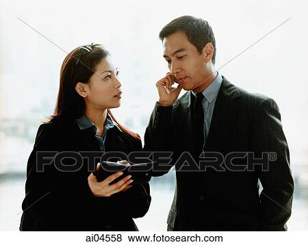 Executives using PDA and cellular phone. View Large Photo Image Stock Photo - Executives using PDA and cellular phone.. Fotosearch
