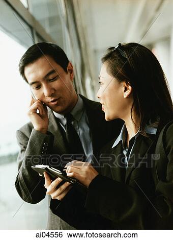 Executives using PDA and cellular phone. View Large Photo Image Stock Photograph - Executives using PDA and cellular phone.. Fotosearch