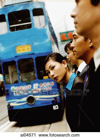 Executives waiting for bus, female executive looking at camera. View Large Photo Image Stock Image - Executives waiting for bus, female executive looking at camera.. Fotosearch