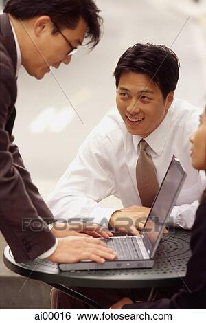 Executives working on laptop computer View Large Photo Image Stock Photograph - Executives working on laptop computer. Fotosearch