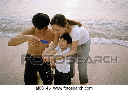 Family playing on beach, elevated view View Large Photo Image Stock Photography - Family playing on beach, elevated view. Fotosearch