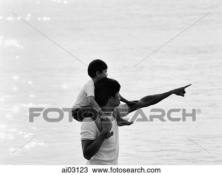 Father and son at beach, son on father's shoulders View Large Photo Image Stock Image - Father and son at beach, son on father's shoulders. Fotosearch
