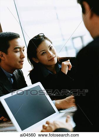 Female executive at meeting table, laptop in foreground. View Large Photo Image Stock Image - Female executive at meeting table, laptop in foreground.. Fotosearch