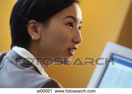 Female executive in front of computer monitor, profile, yellow background View Large Photo Image Stock Image - Female executive in front of computer monitor, profile, yellow background. Fotosearch