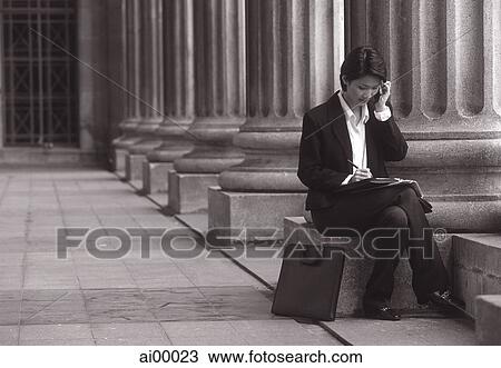 Female executive sitting, using cellular phone View Large Photo Image Stock Image - Female executive sitting, using cellular phone. Fotosearch