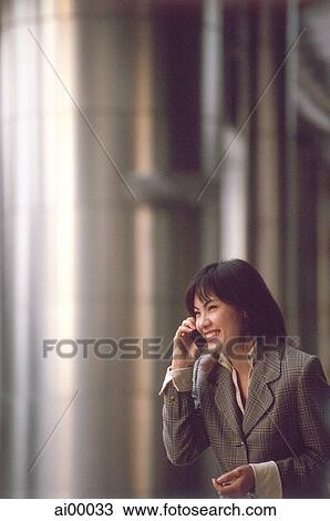 Female executive talking on cellular phone View Large Photo Image Stock Image - Female executive talking on cellular phone. Fotosearch