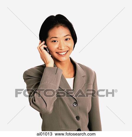 Female executive talking on cellular phone, white background View Large Photo Image Stock Image - Female executive talking on cellular phone, white background. Fotosearch