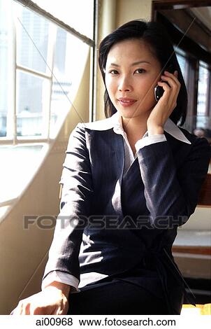 Female executive talking on cellular phone, portrait View Large Photo Image Stock Photo - Female executive talking on cellular phone, portrait. Fotosearch