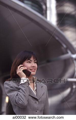 Female executive using cellular phone View Large Photo Image Stock Image - Female executive using cellular phone. Fotosearch