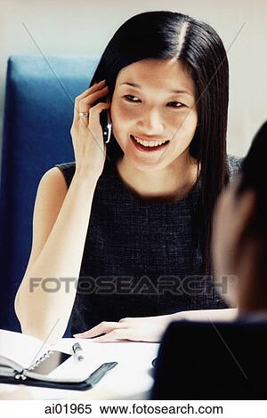 Female executive using cellular phone in cafe View Large Photo Image Stock Photography - Female executive using cellular phone in cafe. Fotosearch