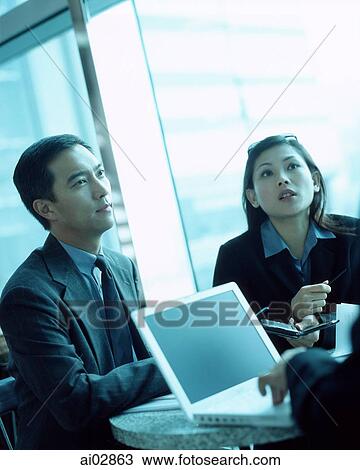 Female executive using PDA, male executive next to her. View Large Photo Image Stock Image - Female executive using PDA, male executive next to her.. Fotosearch