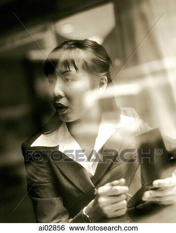 Female executive using PDA seen through glass window. View Large Photo Image Stock Photograph - Female executive using PDA seen through glass window.. Fotosearch