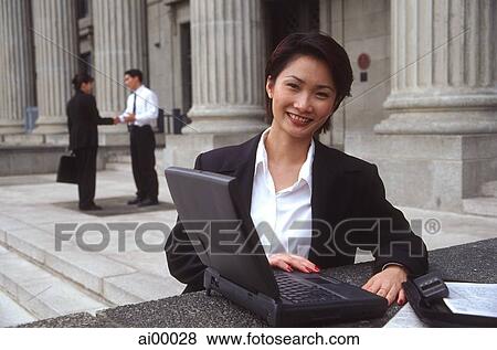 Female executive with laptop computer, smiling View Large Photo Image Stock Photo - Female executive with laptop computer, smiling. Fotosearch