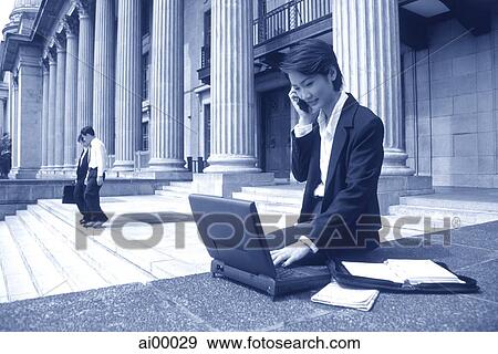 Female executive with laptop computer and cellular phone View Large Photo Image Stock Photo - Female executive with laptop computer and cellular phone. Fotosearch