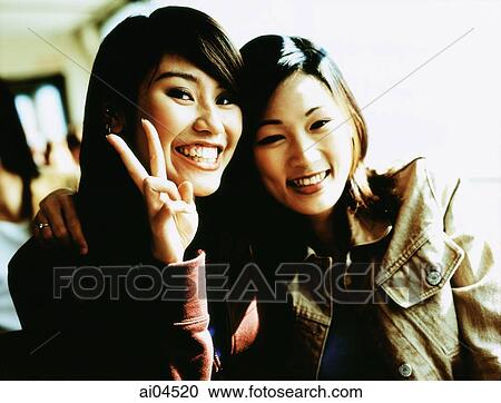 Stock Image - Female friends smiling, portrait.. Fotosearch