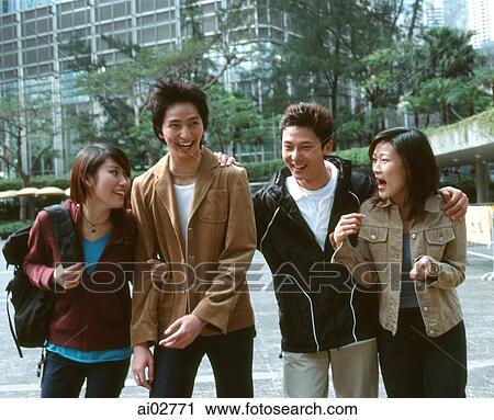 Four young adults walking and laughing outdoors. View Large Photo Image Stock Image - Four young adults walking and laughing outdoors.. Fotosearch