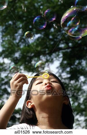 Girl blowing bubbles View Large Photo Image Stock Photograph - Girl blowing bubbles. Fotosearch