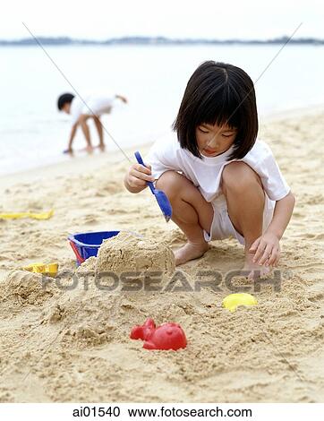 Girl playing at the beach View Large Photo Image Stock Image - Girl playing at the beach. Fotosearch