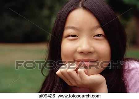 Girl with hand on chin View Large Photo Image Stock Photograph - Girl with hand on chin. Fotosearch