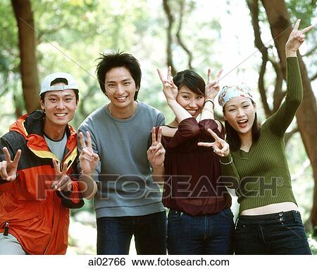 Stock Photograph - Group of friends making v-sign.. Fotosearch