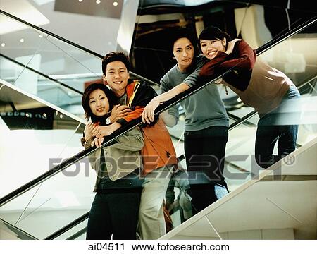 Group of friends on escalator. View Large Photo Image Stock Image - Group of friends on escalator.. Fotosearch