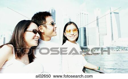Group of friends talking, city skyline in background View Large Photo Image Stock Image - Group of friends talking, city skyline in background. Fotosearch