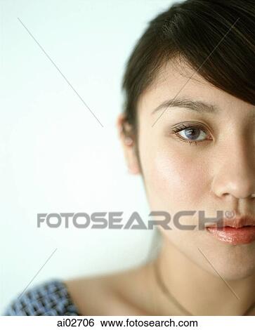 Stock Photograph - Half of woman's face, portrait.. Fotosearch