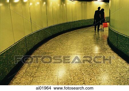 Hong Kong, man and woman walking in MTR (subway) station View Large Photo Image Picture - Hong Kong, man and woman walking in MTR (subway) station. Fotosearch