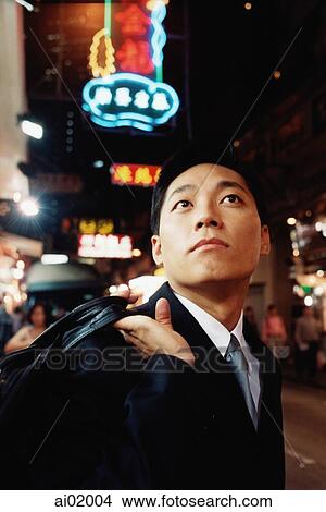 Hong Kong, man looking up, carrying briefcase over shoulder View Large Photo Image Picture - Hong Kong, man looking up, carrying briefcase over shoulder. Fotosearch