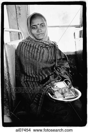 India, Dharamsala, Indian girl on bus holding Hindu icons. View Large Photo Image Picture - India, Dharamsala, Indian girl on bus holding Hindu icons.. Fotosearch
