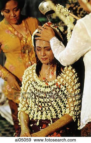 Stock Photo - Indonesia, A bride undergoing a purification ritual of Javanese origin on the first day of a two-day wedding celebration.. Fotosearch