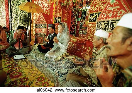 Indonesia, a Muslim cleric reading from the Koran to bind bride and groom in marriage. View Large Photo Image Stock Image - Indonesia, a Muslim cleric reading from the Koran to bind bride and groom in marriage.. Fotosearch