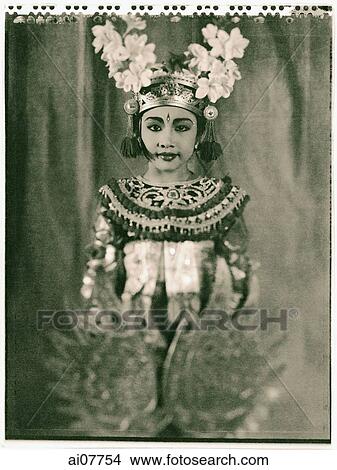 Picture - Indonesia, Bali, Amlapura, Condong dancer in full costume holding golden wings.. Fotosearch