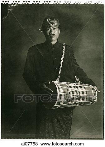 Indonesia, Bali, Amlapura, Gamelan player holding drum. View Large Photo Image Stock Photo - Indonesia, Bali, Amlapura, Gamelan player holding drum.. Fotosearch